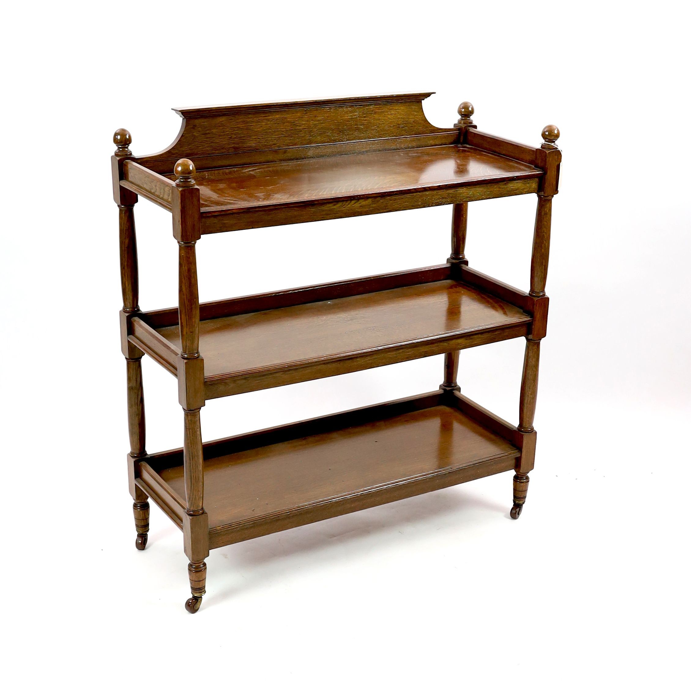 An Edwardian oak three tier buffet, width 104cm depth 40cm height 114cm